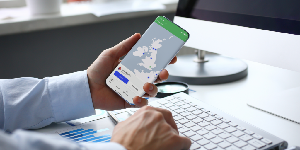 Stock image of a businessman's hands holding a phone showing NordVPN app 