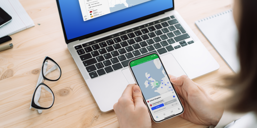 Stock image showing NordVPN screen on a mobile phone and laptop