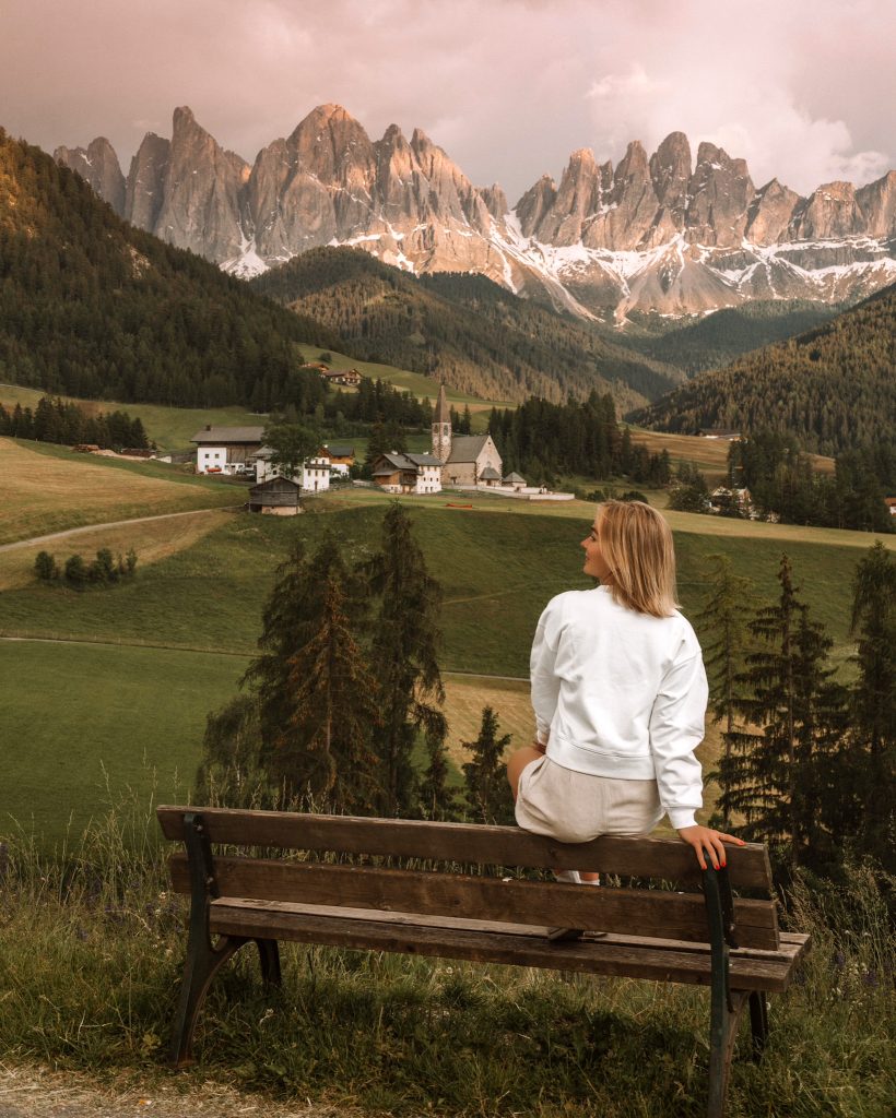 A girl watching sunset in the Dolomites