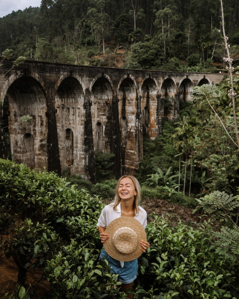 Photo of a girl in front of a Nine Arch Bridge in Sri Lanka