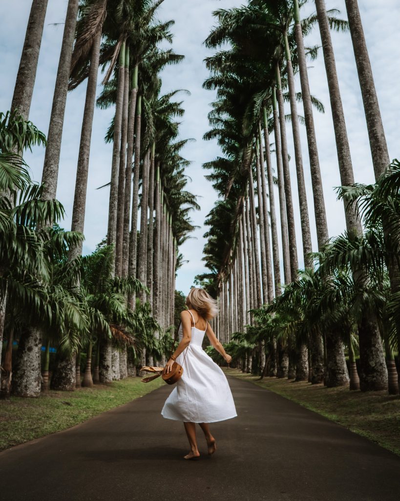 A girl twirling in Royal Botanical Gardens in Kandy, Sri Lanka