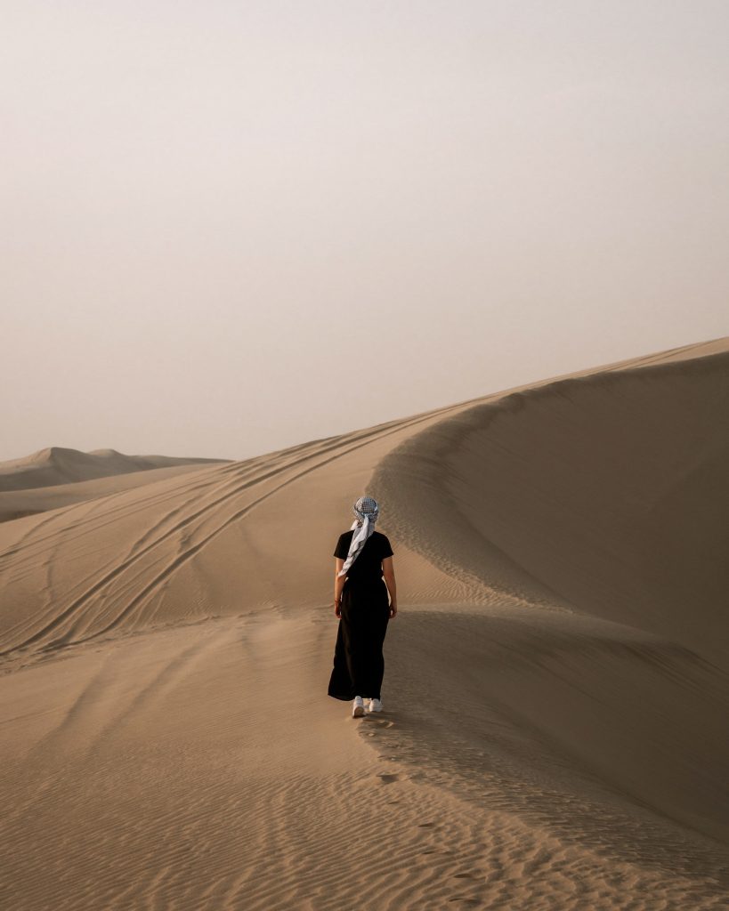 A photo at girl walking at the desert in Doha