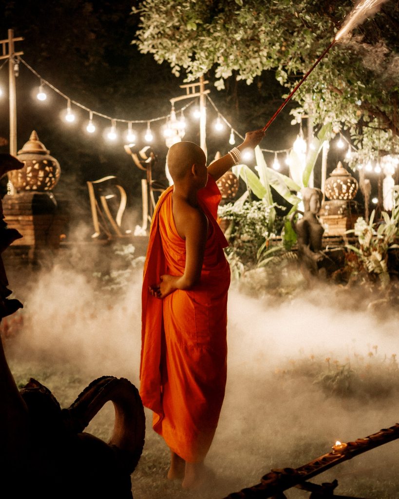 Monk with fireworks at Wat Lok Moli