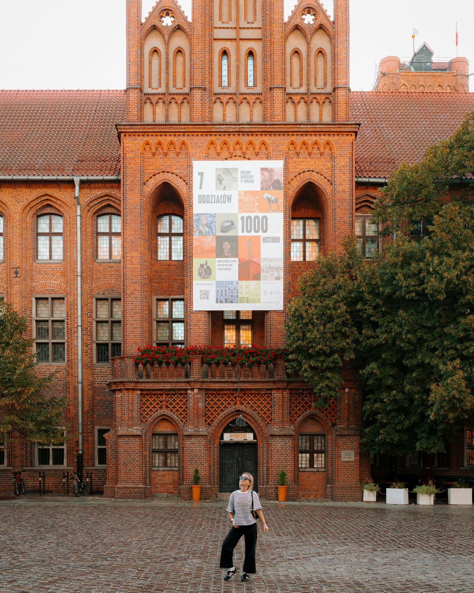 Aga on the run in front of the Town Hall in Torun, Poland by Aga on the run
